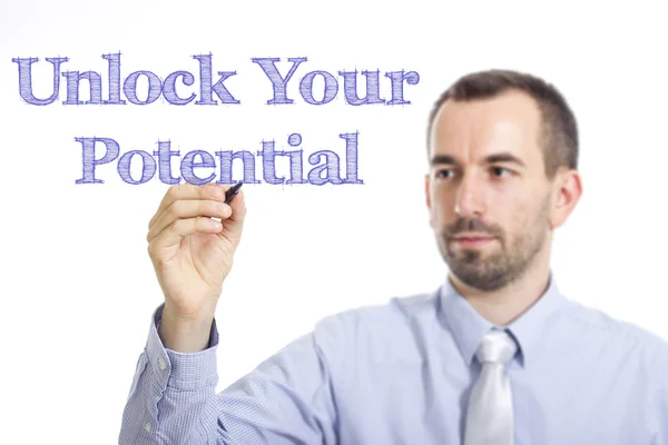 Desbloquear seu potencial - Jovem empresário escrevendo texto azul — Fotografia de Stock