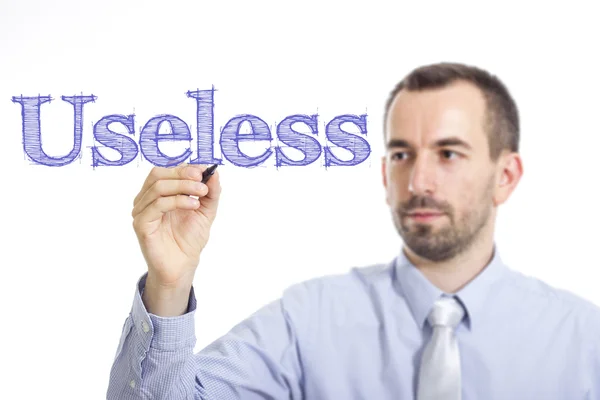 Useless - Молодий підприємець пише синій текст — стокове фото