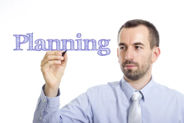 Planering - ung affärsman skriver blå text — Stockfoto