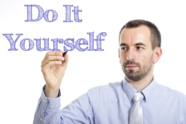 Do It Yourself - Young businessman writing blue text on transparent surface