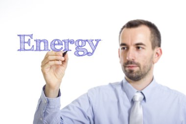 Energy - Young businessman writing blue text on transparent surface