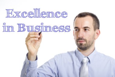 Excellence in Business - Young businessman writing blue text