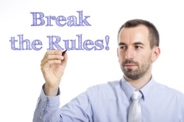 Break the Rules! - Young businessman writing blue text on transparent surface