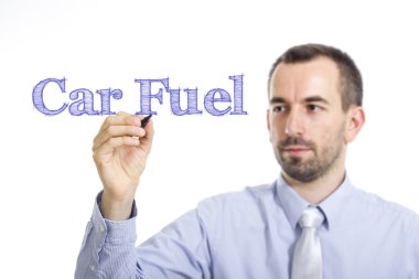 Car Fuel - Young businessman writing blue text on transparent surface