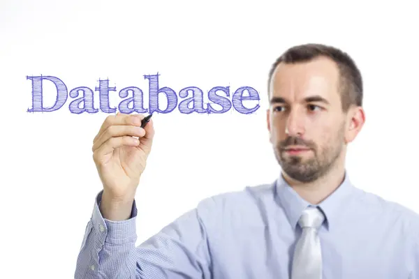 Database - Giovane imprenditore che scrive testo blu su superficie trasparente — Foto Stock