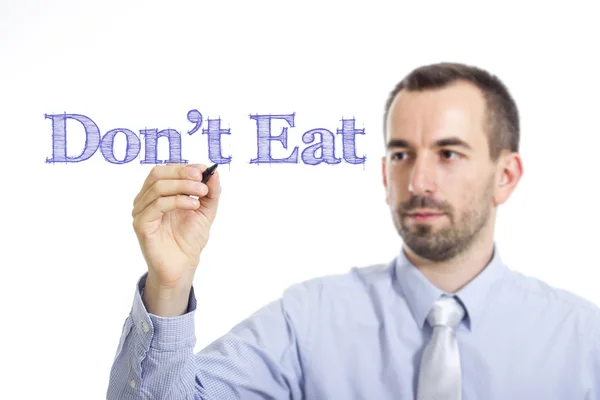 Don 't eat - junger Geschäftsmann schreibt blauen Text auf transparente Oberfläche — Stockfoto