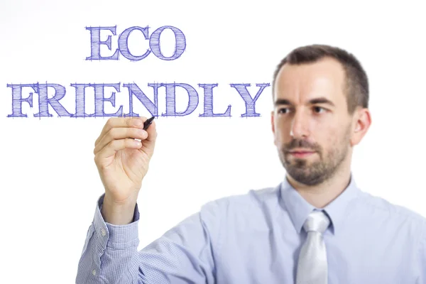 ECO FRIENDLY - Giovane imprenditore che scrive testo blu su superficie trasparente — Foto Stock