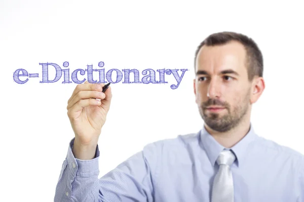 E-Dictionary - Jovem empresário escrevendo texto azul na superfície transparente — Fotografia de Stock