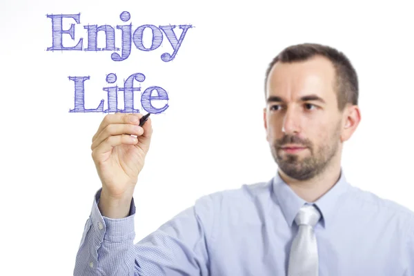 Enjoy Life - Young businessman writing blue text on transparent surface — Stok fotoğraf