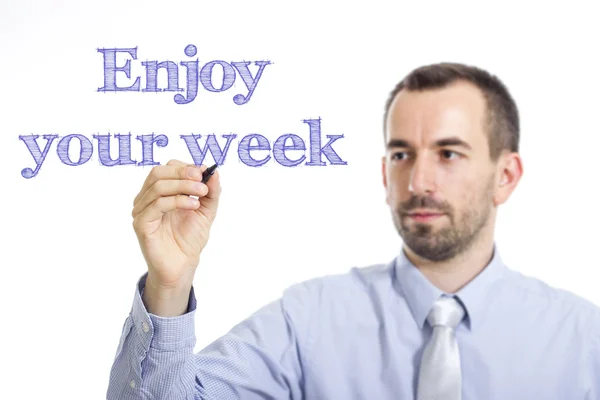 Disfrute de su semana - Joven hombre de negocios escribiendo texto azul en la superficie transparente —  Fotos de Stock