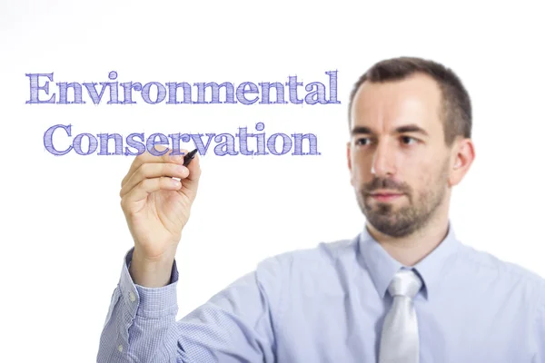 Conservazione dell'ambiente - Giovane imprenditore che scrive testo blu su superficie trasparente — Foto Stock