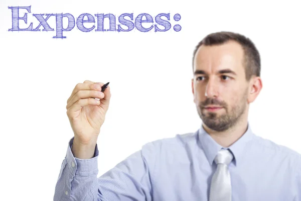Expenses: - Young businessman writing blue text — Φωτογραφία Αρχείου