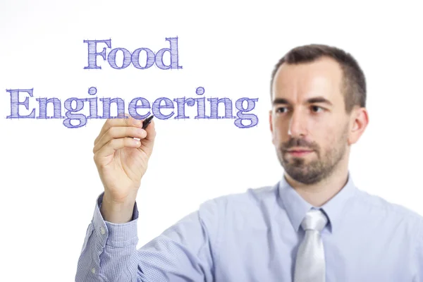 Inżynierii żywności - młody biznesmen pisania niebieski tekst na powierzchni — Zdjęcie stockowe