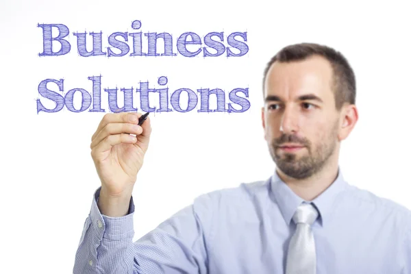 Soluções de negócios - Jovem empresário escrevendo texto azul na superfície transparente — Fotografia de Stock