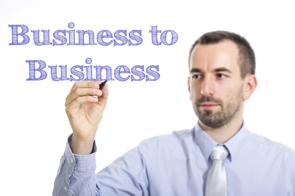 Business to Business - Young businessman writing blue text on transparent surface — Stock Photo, Image