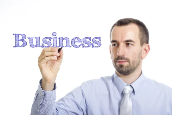 Business - Young businessman writing blue text on transparent surface — Stock Photo, Image