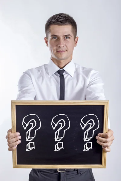 Three question mark - Young businessman holding chalkboard — Stock Photo, Image