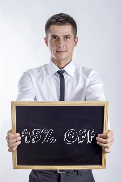45 процентов скидки - Молодой бизнесмен держит доску — стоковое фото
