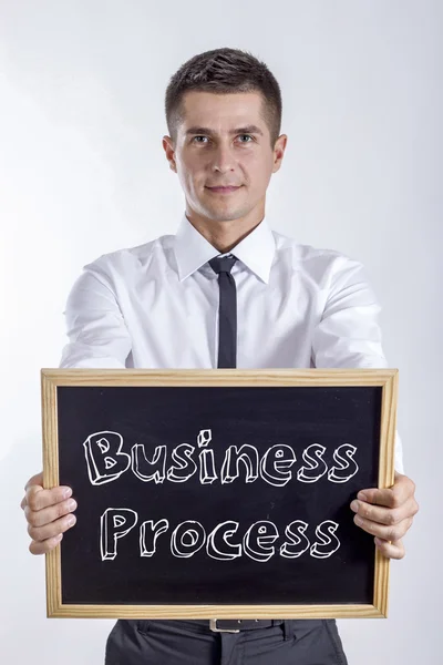ビジネス プロセス - テキストと黒板を保持している青年実業家 — ストック写真