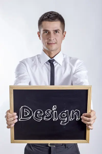 Design - Young businessman holding chalkboard with text — Stock Photo, Image
