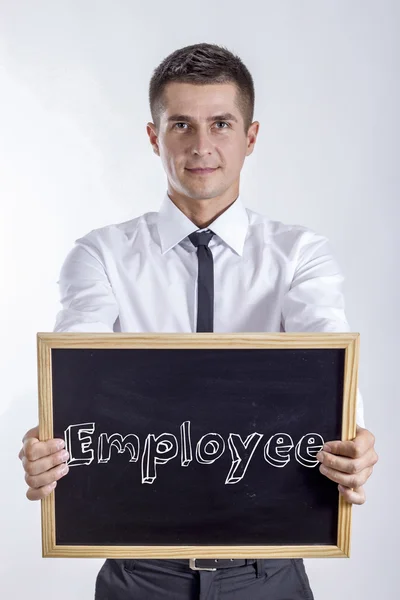 Medarbetare - ung affärsman holding svarta tavlan med text — Stockfoto