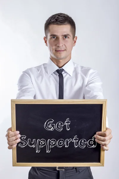 Get stöds - ung affärsman holding svarta tavlan — Stockfoto