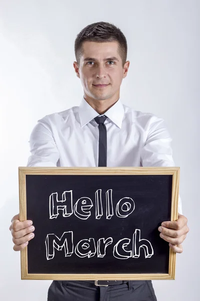 Olá March! - Jovem empresário segurando quadro — Fotografia de Stock