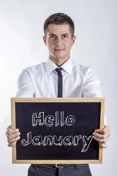 Ciao gennaio - Giovane uomo d'affari in possesso di lavagna — Foto Stock
