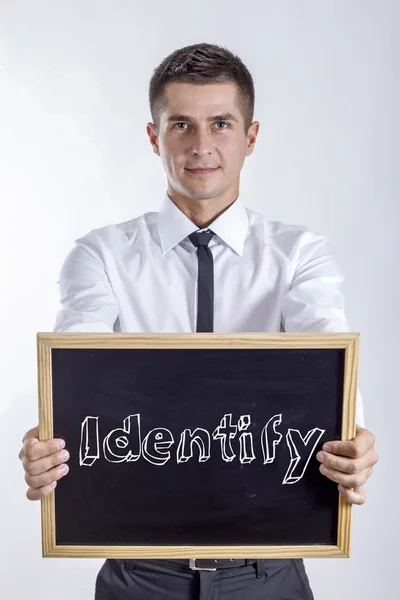 Identify - Young businessman holding chalkboard — Stock Photo, Image