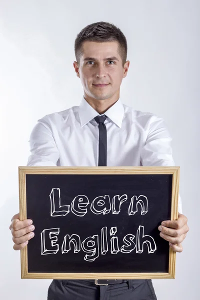 Английский язык - молодой бизнесмен с доской в руках — стоковое фото