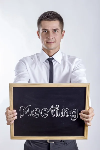 Reunião - Jovem empresário segurando quadro — Fotografia de Stock