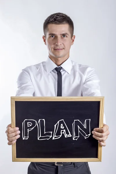 Plan - ung affärsman holding svarta tavlan — Stockfoto