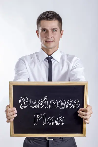 Business Plan - Young businessman holding chalkboard with text — Stock Photo, Image