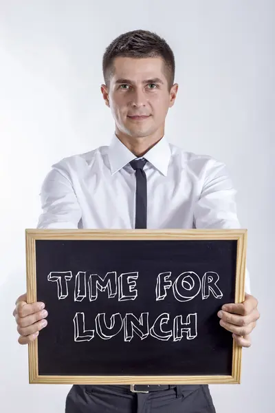 Czas na obiad – młody biznesmen posiadania tablicy — Zdjęcie stockowe