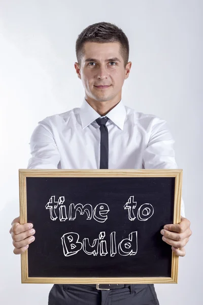 Tempo para construir - Jovem empresário segurando quadro — Fotografia de Stock