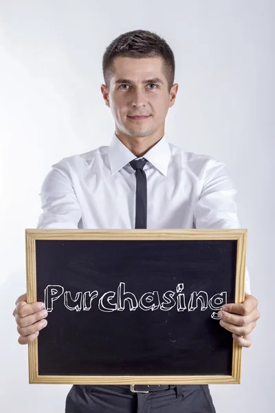 Purchasing - Young businessman holding chalkboard — Stock Photo, Image