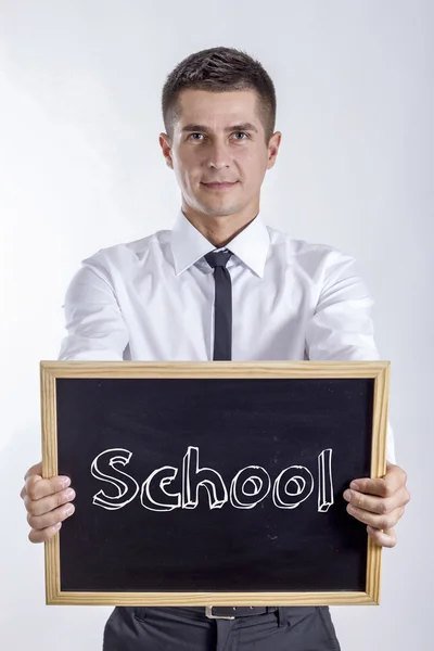 Escola - Jovem empresário segurando quadro — Fotografia de Stock