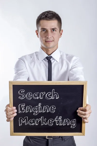 Search Engine Marketing SEM - Young businessman holding chalkboard — Stock Photo, Image