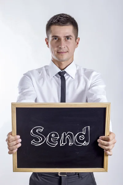 Send - Young businessman holding chalkboard — Stock Photo, Image