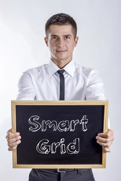 Smart Grid - ung affärsman holding svarta tavlan — Stockfoto