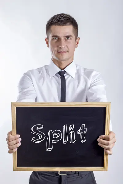 Split - fiatal üzletember gazdaság chalkboard — Stock Fotó