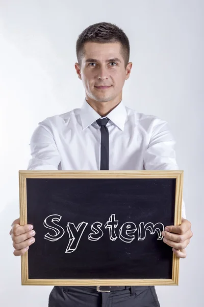 Σύστημα - νέος επιχειρηματίας που κατέχουν Μαυροπίνακας — Φωτογραφία Αρχείου