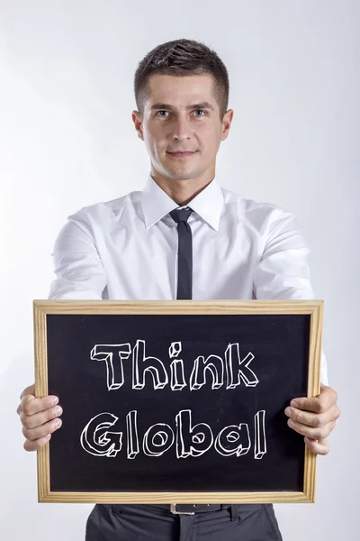 Že globální - mladý podnikatel drží tabuli — Stock fotografie