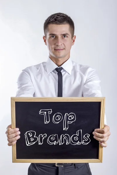 Top Brands - Young businessman holding chalkboard — Stock Photo, Image