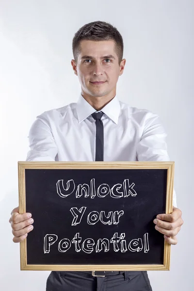 Desbloquear seu potencial - Jovem empresário segurando quadro — Fotografia de Stock