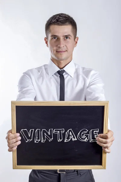 VINTAGE - Joven hombre de negocios sosteniendo pizarra —  Fotos de Stock