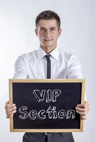 Secção VIP - Jovem empresário segurando quadro — Fotografia de Stock