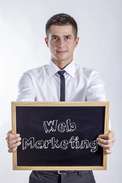 Web Marketing - Young businessman holding chalkboard — Stock Photo, Image