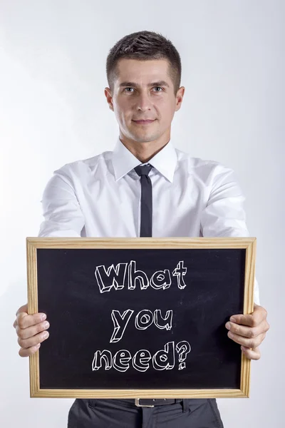 ¿Qué necesitas? - Joven hombre de negocios sosteniendo pizarra — Foto de Stock