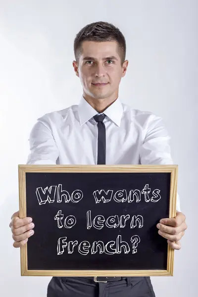 Wie wil om Frans te leren? -Jonge zakenman bedrijf schoolbord — Stockfoto